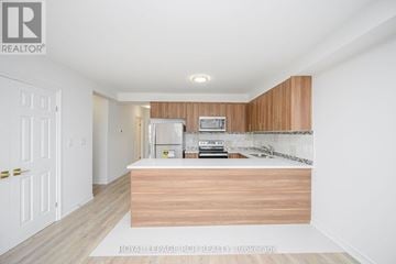 Orangeville multi-family for rent - A kitchen with wooden cabinets and a countertop.