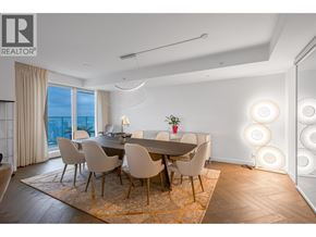 Vancouver apartment for rent - A dining room with a table set for four and a view of the city.
