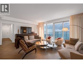 Vancouver apartment for rent - A living room with a large window overlooking the city.