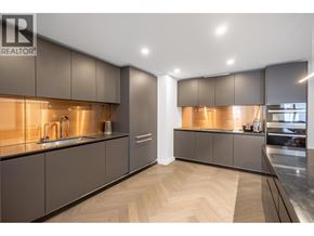 Vancouver apartment for rent - A modern kitchen with dark wood cabinets and a sleek design.