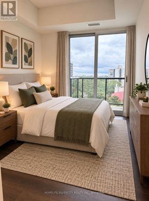Toronto (Glenfield-Jane Heights) condo for rent - A bedroom with a large bed and a view of the city.