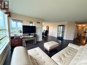 Markham (Aileen-Willowbrook) condo for rent - A living room with a white couch and a television.
