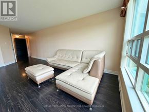 Markham (Aileen-Willowbrook) condo for rent - A living room with a couch and ottoman.
