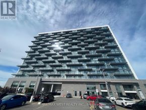 Hamilton (Riverdale) condo for rent - A modern multi-story building with a parking lot in front.