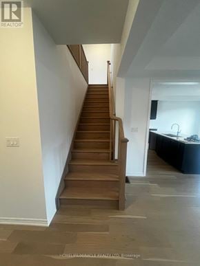 Barrie (Painswick South) apartment for rent - A staircase with wooden steps and a light brown carpet.