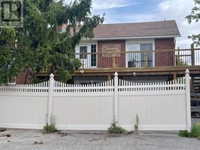 East Gwillimbury apartment for rent - A white picket fence in front of a brick house.