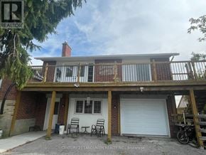 East Gwillimbury apartment for rent - A house with a balcony and a garage door.
