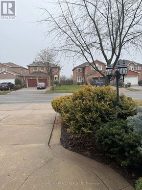 Mississauga (East Credit) apartment for rent - A residential street with houses and parked cars.