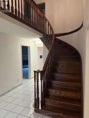 Mississauga (East Credit) apartment for rent - A wooden staircase with a white tiled floor.