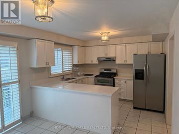 Mississauga (East Credit) apartment for rent - A kitchen with white cabinets and a refrigerator.