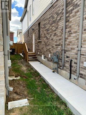 North Dumfries apartment for rent - A brick building with a white wall and a concrete walkway.