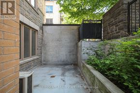 Toronto (Dovercourt-Wallace Emerson-Junction) townhouse for rent - A brick wall with a window and a sign that says REALTOR.