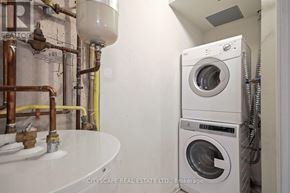 Toronto (Dovercourt-Wallace Emerson-Junction) townhouse for rent - A washing machine is stacked on top of another in a small laundry room.