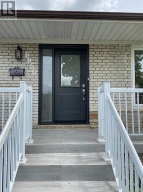 Mississauga (Malton) apartment for rent - A house with a black front door and white railings.
