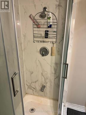 Mississauga (Mineola) apartment for rent - A shower with a marble wall and a glass door.