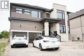 Brant (Paris) apartment for rent - Two cars are parked in front of a modern house.