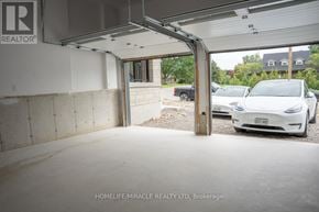 Brant (Paris) apartment for rent - A white car is parked in a garage with a sign that reads "REALTOR".