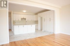 Brant (Paris) apartment for rent - A white kitchen with wooden floors and white cabinets.