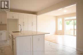 Brant (Paris) apartment for rent - A kitchen with white cabinets and a marble floor.