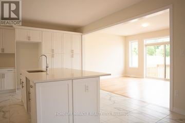 Brant (Paris) apartment for rent - A kitchen with white cabinets and a marble floor.