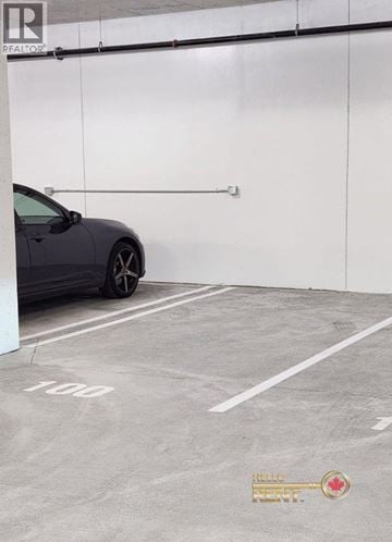 North Vancouver apartment for rent - A grey car is parked in a parking space with the number 100 on the ground.