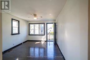 Oshawa (Central) apartment for rent - A room with a ceiling fan and a door leading outside.