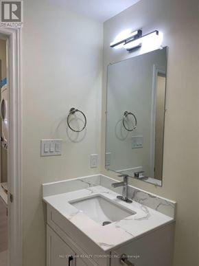 Whitby apartment for rent - A bathroom with a sink, mirror, and light fixture.