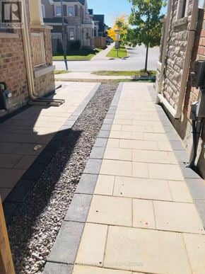 Whitby apartment for rent - A sidewalk with a gravel strip in the middle.
