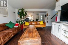 Toronto (Clairlea-Birchmount) apartment for rent - A living room with a brown leather couch, a wooden coffee table, and a white cabinet.