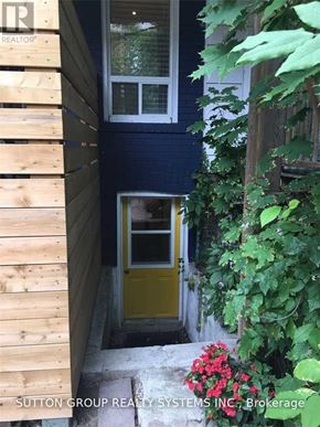 Toronto (Woodbine Corridor) apartment for rent - A doorway with a yellow door and a window above it.