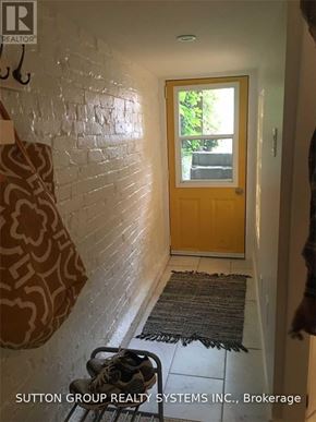 Toronto (Woodbine Corridor) apartment for rent - A hallway with a door and a rug on the floor.