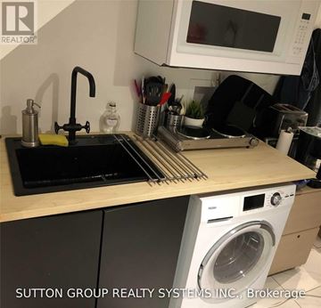 Toronto (Woodbine Corridor) apartment for rent - A kitchen counter with a washing machine underneath it.