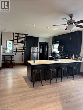 Brantford apartment for rent - A kitchen with a bar area and a ceiling fan.