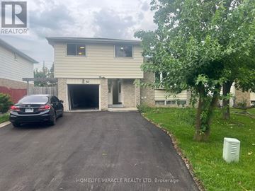 Brampton (Northgate) apartment for rent - A car is parked in front of a two-story house with a garage.