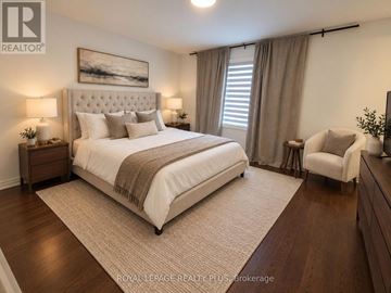 Oakville (Nw Northwest) apartment for rent - A bedroom with a large bed and a painting on the wall.