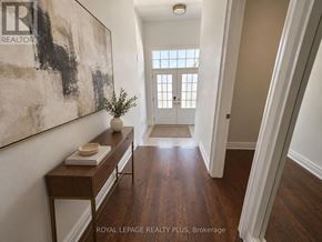Oakville (Nw Northwest) apartment for rent - A hallway with a wooden floor and a large painting on the wall.