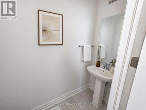 Oakville (Nw Northwest) apartment for rent - A bathroom with a white sink and a framed picture on the wall.