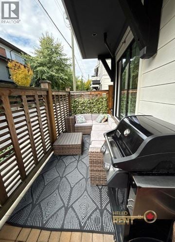 North Vancouver townhouse for rent - A black grill with the words "Hello Pant" on it is on a patio with a patterned rug.