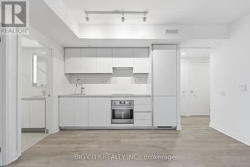 Toronto (Thorncliffe Park) condo for rent - A white kitchen with a sink and a refrigerator.