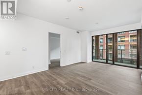 Toronto (Thorncliffe Park) condo for rent - A spacious room with a sliding glass door leading to a balcony.
