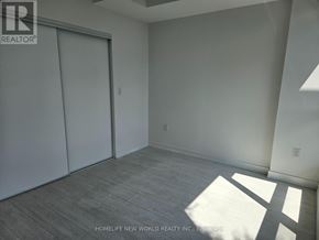 Toronto (York University Heights) condo for rent - A room with a sliding door and a wooden floor.