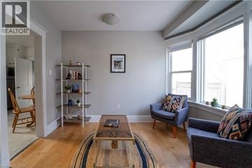 Kitchener apartment for rent - A living room with a brown rug and a coffee table.