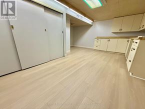 Ottawa apartment for rent - A room with white cupboards and a wooden floor.