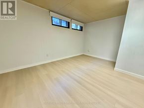 Ottawa apartment for rent - A room with wooden flooring and two windows.