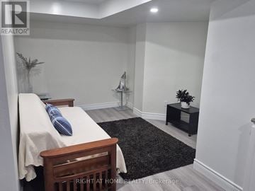 Whitby (Pringle Creek) apartment for rent - A bedroom with a bed, nightstand, and a plant.