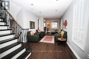 Mississauga (Churchill Meadows) apartment for rent - A living room with a staircase and a rug.