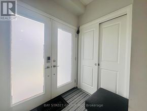 Niagara Falls (Brown) townhouse for rent - A white door with a glass window is on the left and a white door is on the right.