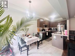 Niagara Falls (Brown) townhouse for rent - A well-lit kitchen with a dining table set for two.