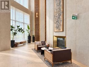 Vaughan (Vaughan Corporate Centre) condo for rent - A living room with a couch, a chair, a coffee table, and a fireplace.