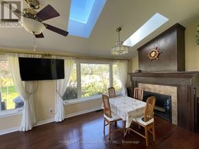 Georgina (Keswick North) apartment for rent - A living room with a fireplace and a TV mounted on the wall.